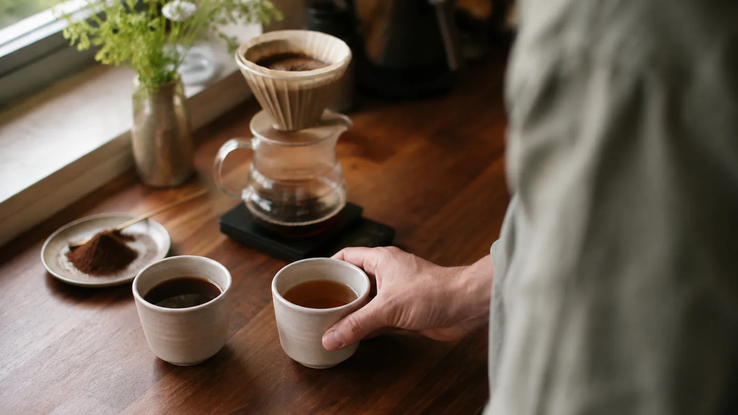 Two similar coffee brews sit side by side, showing lighter and darker concentration without ranking either one.