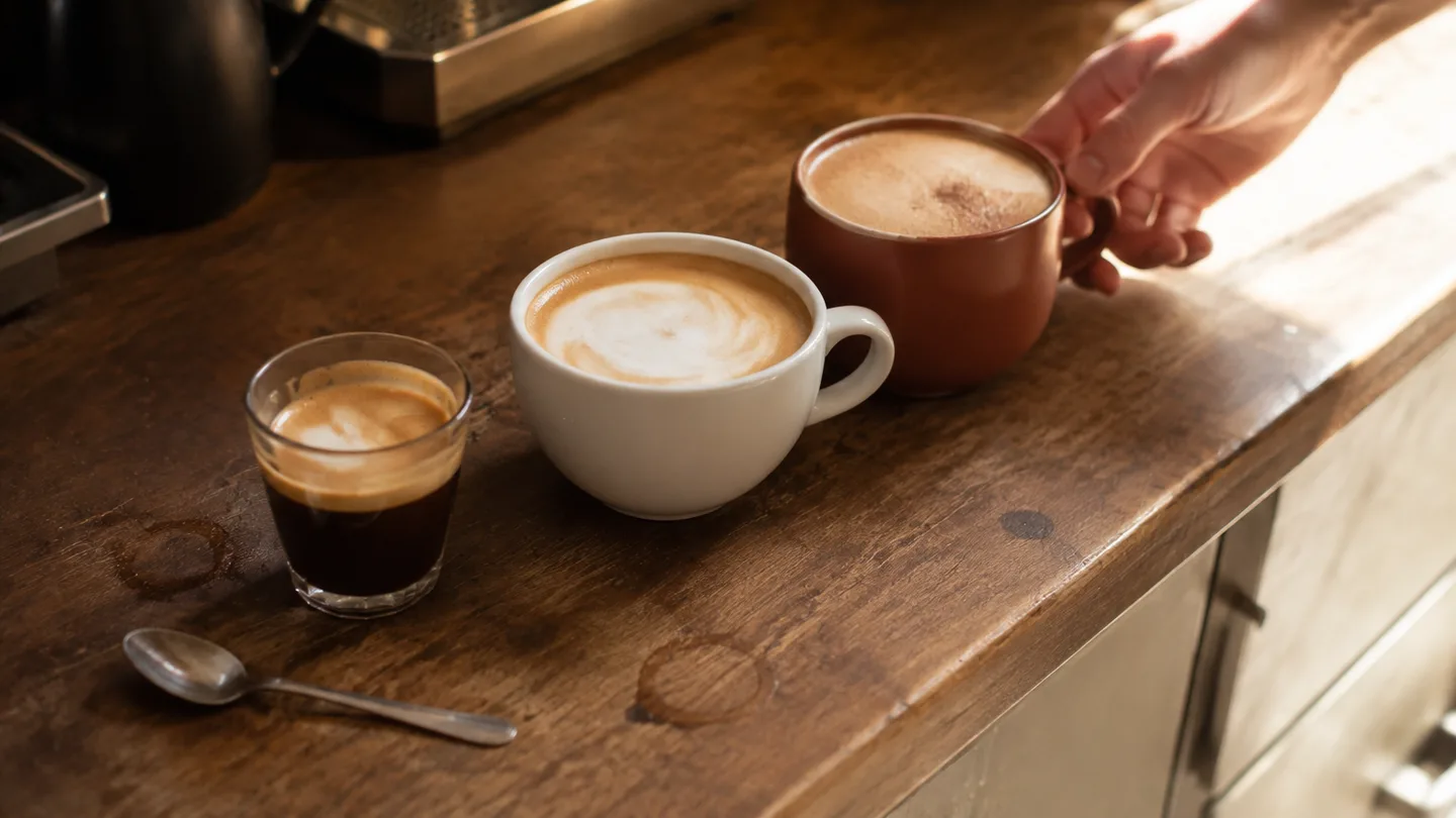 Three espresso drinks show different milk and foam levels, from a dark cortado to a milky latte and mocha.